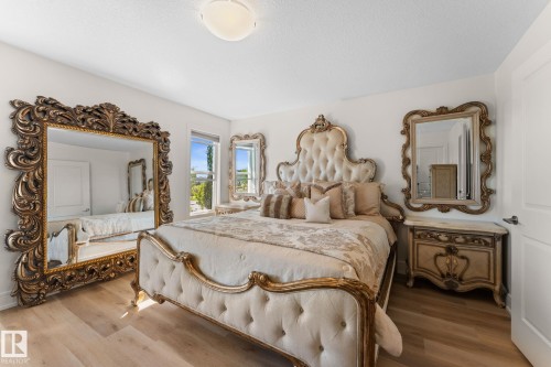 White walls, light wood-finish flooring, and a flush mount ceiling light - 5415 167A Avenue Nw, Edmonton, AB - Indoor Photo Showing Bedroom