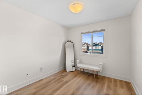 Recessed window with white trim, wood-finish flooring, white walls, and a ceiling-mounted light fixture - 5415 167A Avenue Nw, Edmonton, AB - Indoor Photo Showing Other Room