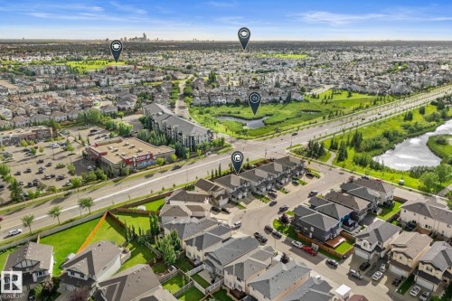 Aerial perspective showcasing residential developments, a commercial center, and undeveloped green spaces - 5415 167A Avenue Nw, Edmonton, AB - Outdoor With View