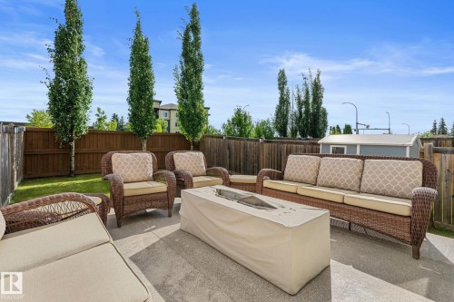 Patio with a concrete surface, wood fence, and mature trees - 5415 167A Avenue Nw, Edmonton, AB - Outdoor