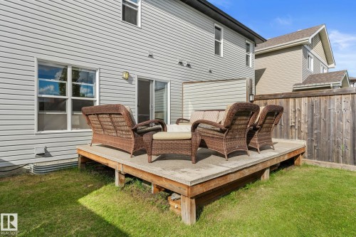 Exterior featuring horizontal siding, ground-level wooden deck, and sliding glass door - 5415 167A Avenue Nw, Edmonton, AB - Outdoor With Deck Patio Veranda With Exterior