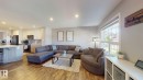 Open-concept living area with wood-finish flooring, recessed lighting, and a large window - 17359 49 Street Nw, Edmonton, AB  - Indoor Photo Showing Living Room 