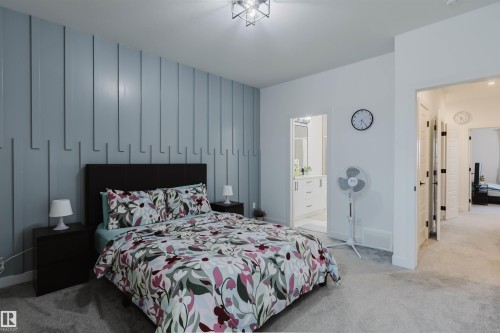 Accent wall with vertical paneling - 104 Meadowview Way, Leduc, AB - Indoor Photo Showing Bedroom