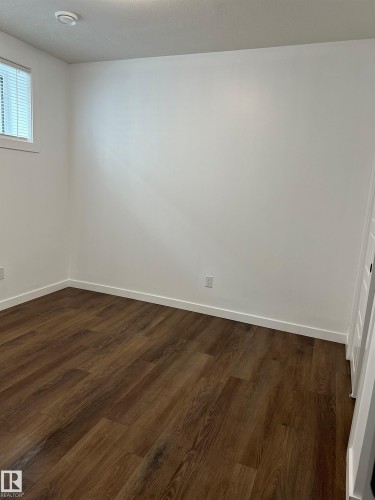 Wood-finish flooring, white walls, and a recessed ceiling light - 104 Meadowview Way, Leduc, AB - Indoor Photo Showing Other Room