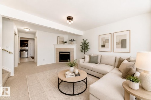 Living area featuring a fireplace with a tiled surround, recessed lighting, and carpeting - 11727 83 Street Nw, Edmonton, AB - Indoor Photo Showing Living Room With Fireplace