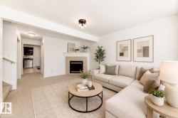 Living area featuring a fireplace with a tiled surround, recessed lighting, and carpeting - 