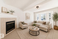 Virtually staged room with illustrating potential of room with furniture, decor and new flooring show a recessed fireplace with a tile surround and mantel - 