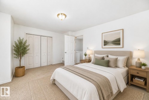 Virtually staged room with illustrating potential of room with furniture, decor and new flooring show a ceiling-mounted brass light fixture, neutral carpeting, and panel bi-fold closet doors - 11727 83 Street Nw, Edmonton, AB - Indoor Photo Showing Bedroom