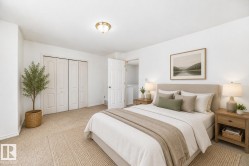 Virtually staged room with illustrating potential of room with furniture, decor and new flooring show a ceiling-mounted brass light fixture, neutral carpeting, and panel bi-fold closet doors - 