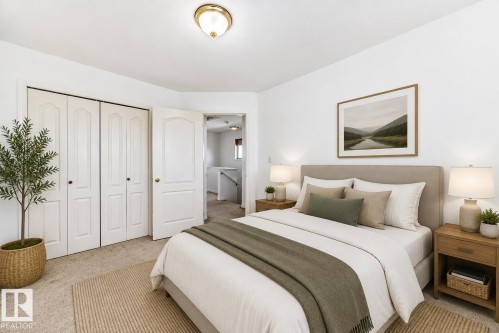 Virtually staged room with illustrating potential of room with furniture, decor and new flooring show a warm neutral wall paint, light-toned carpet flooring, white bi-fold closet doors, and an overhead flush mount light fixture - 11727 83 Street Nw, Edmonton, AB - Indoor Photo Showing Bedroom