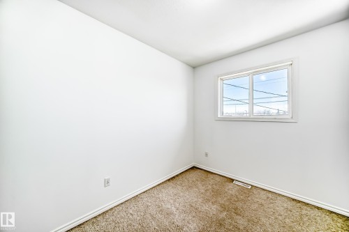 White walls, neutral carpet, and a white-framed window - 11727 83 Street Nw, Edmonton, AB - Indoor Photo Showing Other Room