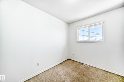 White walls, neutral carpet, and a white-framed window - 