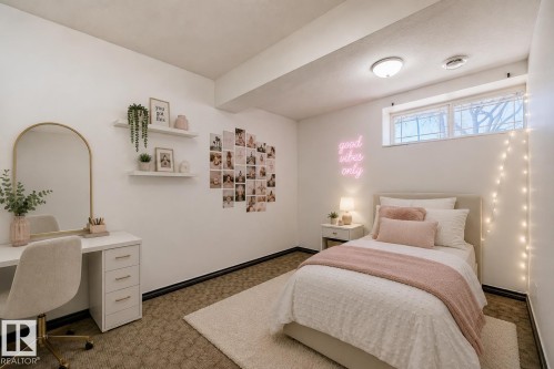 Virtually staged room with illustrating potential of room with furniture, decor and new flooring show a built-in shelving, recessed window, wall-mounted lighting, and carpet flooring - 11727 83 Street Nw, Edmonton, AB - Indoor Photo Showing Bedroom