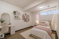 Virtually staged room with illustrating potential of room with furniture, decor and new flooring show a built-in shelving, recessed window, wall-mounted lighting, and carpet flooring - 