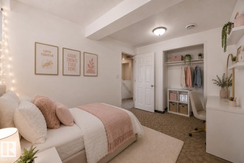 Virtually staged room with illustrating potential of room with furniture, decor and new flooring show a recessed closet with built-in shelving, durable carpeting, and a flush-mount ceiling light fixture - 11727 83 Street Nw, Edmonton, AB - Indoor Photo Showing Bedroom