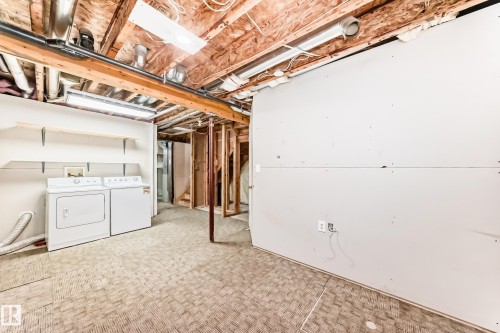 Laundry area with a washer and dryer, exposed ceiling joists, and partial wall framing - 11727 83 Street Nw, Edmonton, AB - Indoor Photo Showing Laundry Room