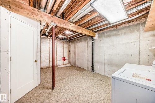 Unfinished basement with exposed ceiling joists, concrete foundation walls, and a patterned floor - 11727 83 Street Nw, Edmonton, AB - Indoor Photo Showing Basement
