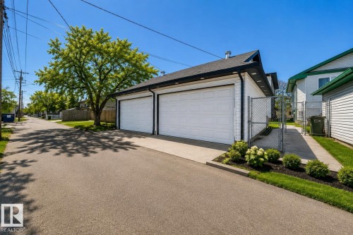 Virtually enhanced image of detached two-car garage with white garage doors and black trim - 11727 83 Street Nw, Edmonton, AB - Outdoor