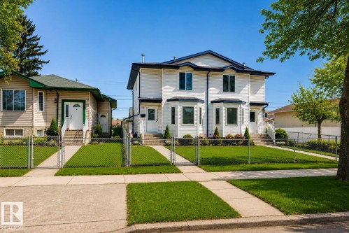Virtually enhanced image of two-story duplex with white siding, bay windows, and a blue trim roof - 11727 83 Street Nw, Edmonton, AB - Outdoor With Facade