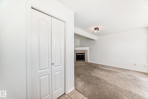 Built-in fireplace with a tile surround and mantel - 11727 83 Street Nw, Edmonton, AB - Indoor Photo Showing Other Room With Fireplace