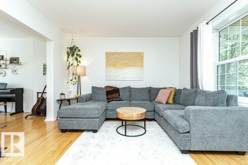Hardwood flooring, white walls, and a large window with natural light - 1539 Kinross Road Nw, Edmonton, AB - Indoor Photo Showing Living Room