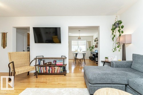 Hardwood flooring throughout, bright white walls, and clear sightlines through interior doorways - 1539 Kinross Road Nw, Edmonton, AB - Indoor Photo Showing Living Room