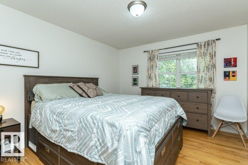 Hardwood flooring, window with natural light, flush mount lighting, and white walls - 1539 Kinross Road Nw, Edmonton, AB - Indoor Photo Showing Bedroom