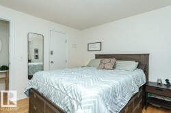 Wood-finish flooring, white walls, and a white ceiling - 