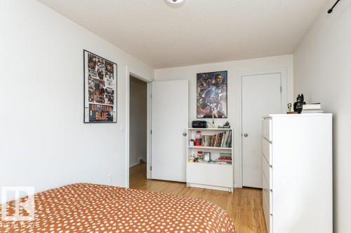 Light-toned wood-finish flooring, white painted walls, and a white ceiling with a textured finish - 1539 Kinross Road Nw, Edmonton, AB - Indoor