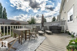 Expansive outdoor deck featuring wood-finish decking and a surrounding privacy fence - 