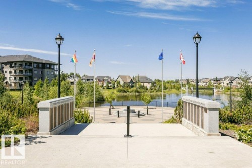 Water feature, surrounding landscaping, paved walkway, integrated lighting, and stone monument - 1539 Kinross Road Nw, Edmonton, AB - Outdoor