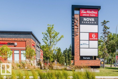 Brick and metal pylon signage featuring multiple tenant displays - 1539 Kinross Road Nw, Edmonton, AB - Outdoor