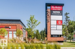 Brick and metal pylon signage featuring multiple tenant displays - 