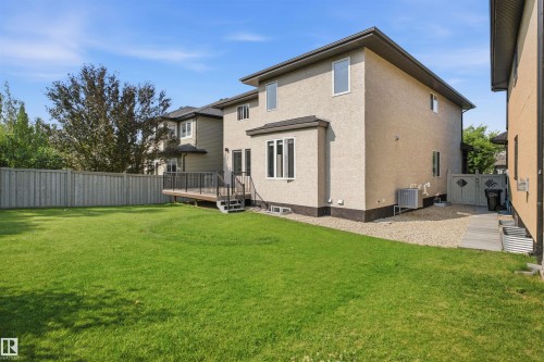 Expansive lawn, multi-level wood-tone deck, stucco exterior, and privacy fencing - 427 Windermere Road Nw, Edmonton, AB - Outdoor