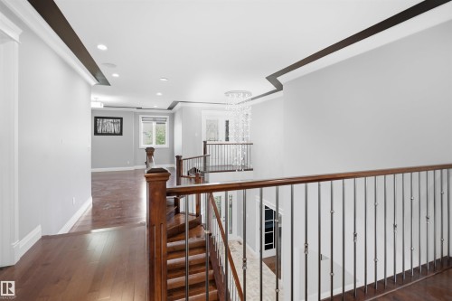 Hardwood flooring throughout, recessed lighting, and a contemporary chandelier - 427 Windermere Road Nw, Edmonton, AB - Indoor Photo Showing Other Room