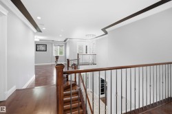 Hardwood flooring throughout, recessed lighting, and a contemporary chandelier - 