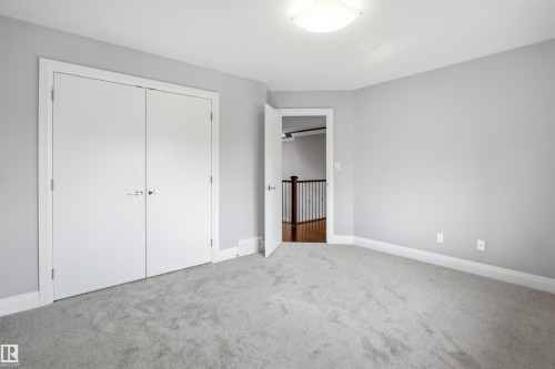 Light gray carpeting and walls, complemented by white trim - 427 Windermere Road Nw, Edmonton, AB - Indoor Photo Showing Other Room