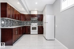 Kitchen featuring dark wood-finish cabinetry, light-toned countertops, tile backsplash, and light-toned tile flooring - 