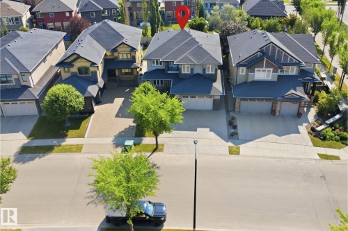 Two-story residence with a dark shingle roof and light-toned siding - 427 Windermere Road Nw, Edmonton, AB - Outdoor With Deck Patio Veranda With Facade