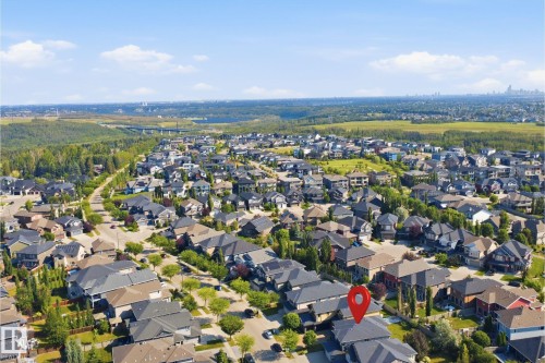 Residential neighborhood setting with varied architectural styles, surrounded by abundant green spaces, and a distant urban skyline - 427 Windermere Road Nw, Edmonton, AB - Outdoor With View