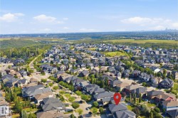 Residential neighborhood setting with varied architectural styles, surrounded by abundant green spaces, and a distant urban skyline - 