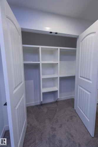 White bi-fold doors with arched top panels - 9632 #1 And #2 110 Ave Nw, Edmonton, AB - Indoor With Storage