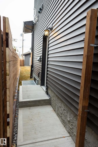 Exterior siding with a built-in wall light fixture and a concrete walkway - 9632 #1 And #2 110 Ave Nw, Edmonton, AB - Outdoor