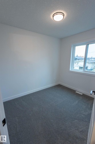 Bright room featuring a window with white trim, gray carpet, and a flush-mount ceiling light - 9632 #1 And #2 110 Ave Nw, Edmonton, AB - Indoor Photo Showing Other Room