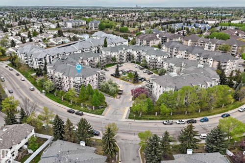 Multi-building complex featuring private balconies, ample parking, and surrounding mature trees - #137 9704 174 St Nw, Edmonton, AB - Outdoor With View