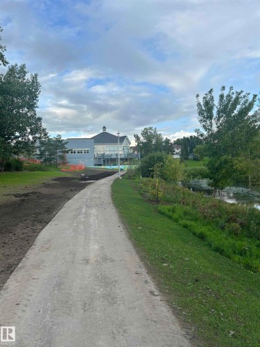 Manicured green space with a paved pathway - #137 9704 174 St Nw, Edmonton, AB - Outdoor With View