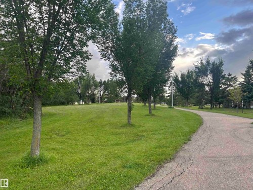 Green space with mature trees and paved pathway - #137 9704 174 St Nw, Edmonton, AB - Outdoor With View