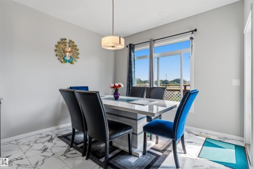 Ceramic tile flooring with a marble-effect finish - 1103 26 Avenue Nw, Edmonton, AB - Indoor Photo Showing Dining Room