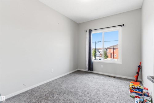 Neutral-toned walls complement the gray carpeting - 1103 26 Avenue Nw, Edmonton, AB - Indoor Photo Showing Other Room