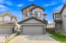 Two-story exterior with multi-toned siding, attached two-car garage, stone accents, and a concrete driveway - 1103 26 Avenue Nw, Edmonton, AB  - Outdoor With Facade 